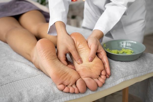 Foot massage therapy session with therapist applying treatment on client's feet